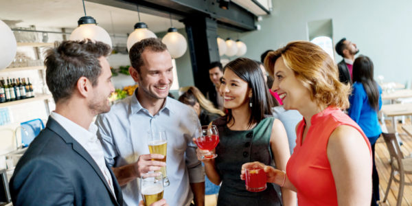 Friends having drinks at a restaurant Group of business friends having drinks after work at a restaurant